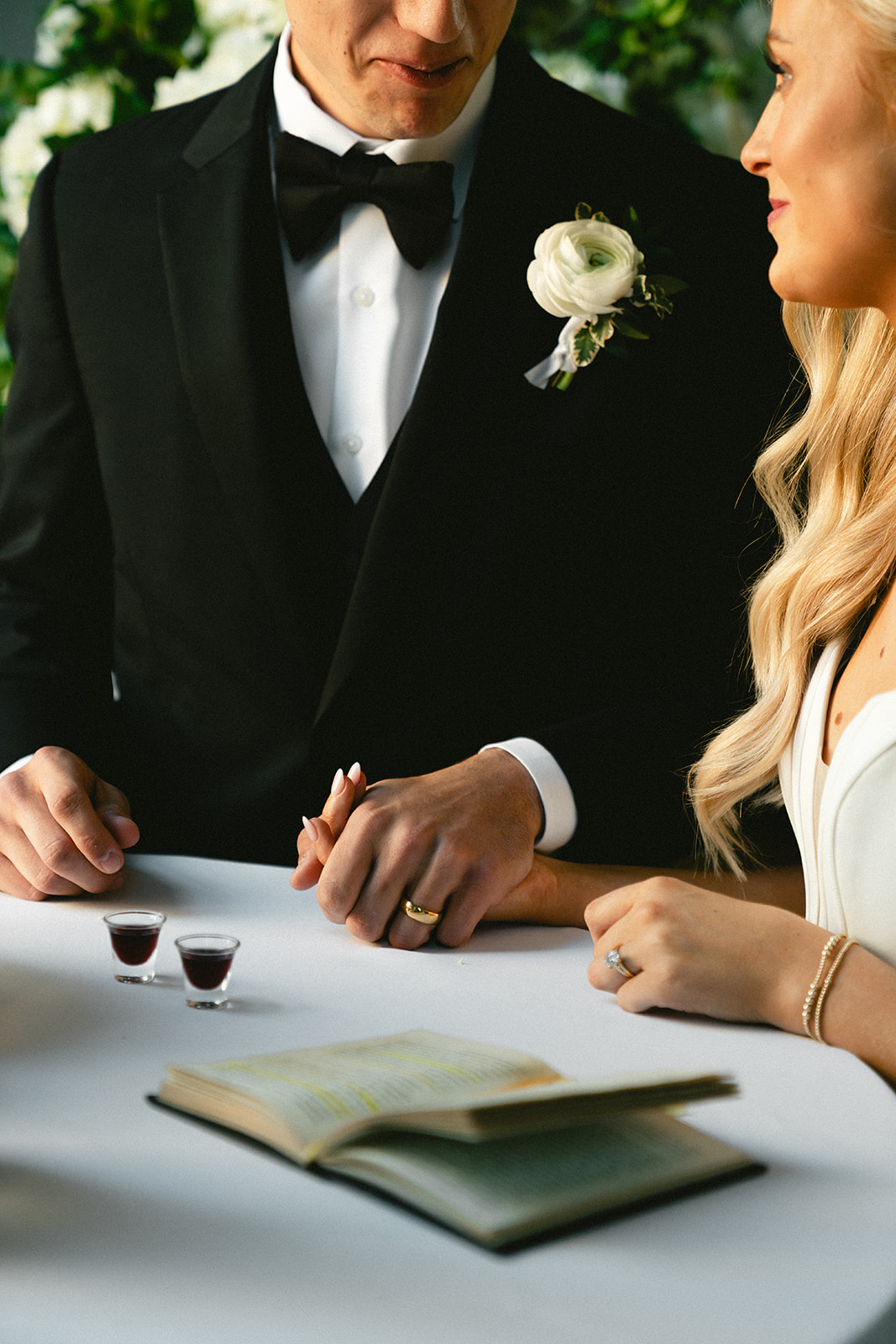 A bride and groom stand with an officiant during their wedding ceremony at Stanly Hall Ballroom