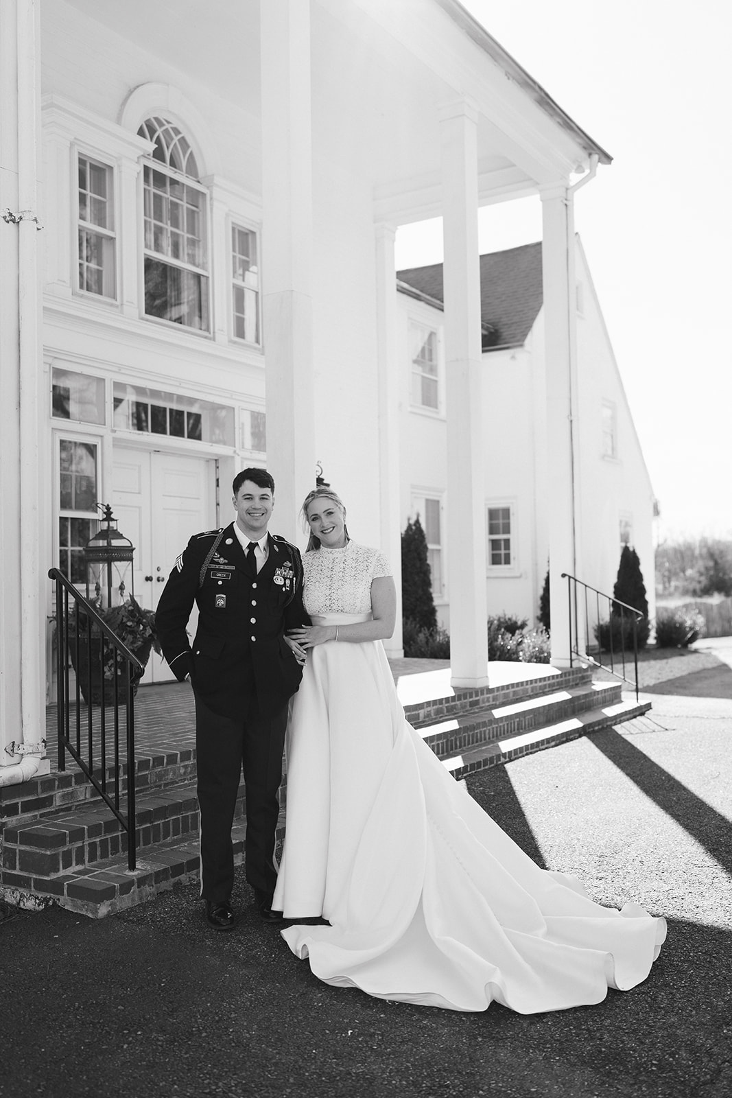 A bride and groom in wedding attire share a kiss outdoors on a sunny day at The Vintage Oak Estate a wedding venue in North Carolina 
