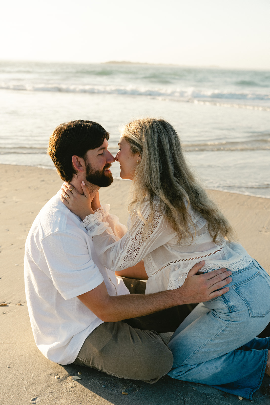 Couple takes beach engagement photos on the East Coast. Taken by a North Carolina engagement photographer