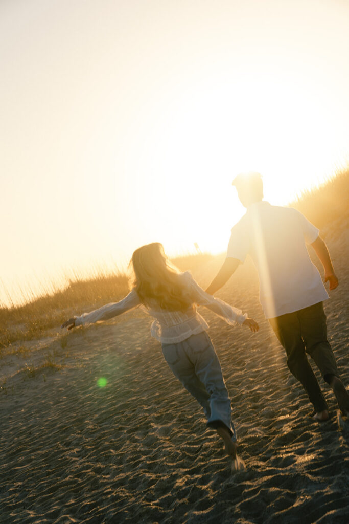 Couple takes beach engagement photos on the East Coast. Taken by a North Carolina engagement photographer