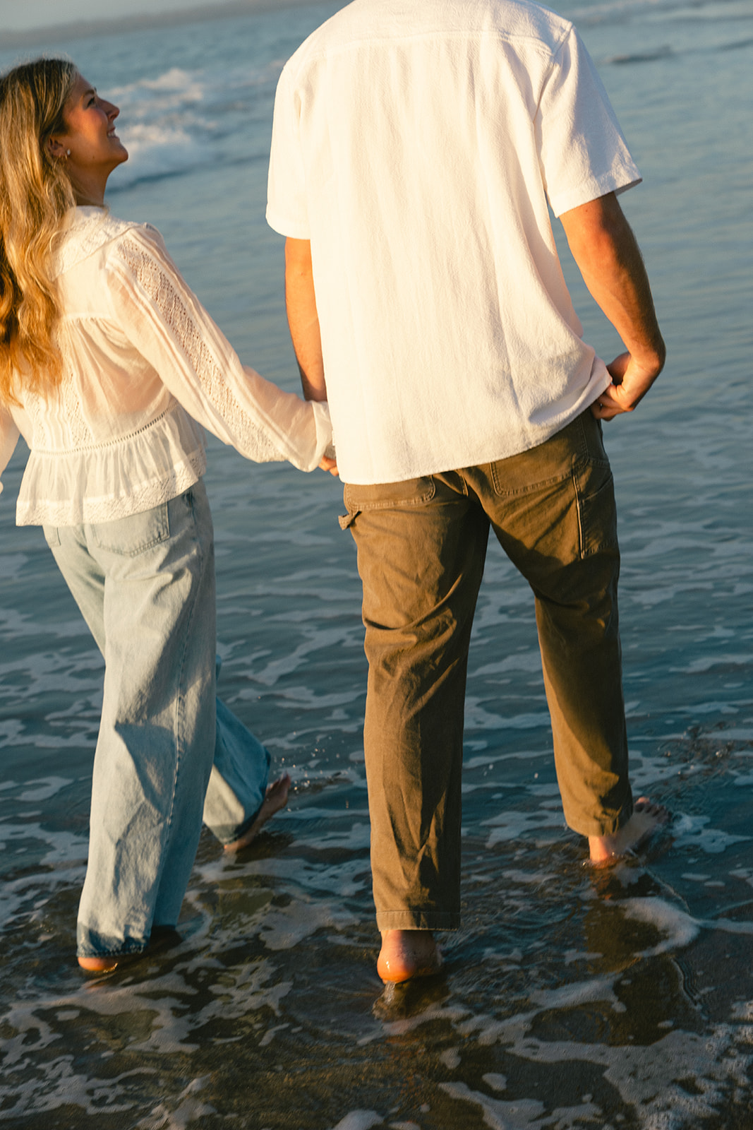 Couple takes beach engagement photos on the East Coast. Taken by a North Carolina engagement photographer