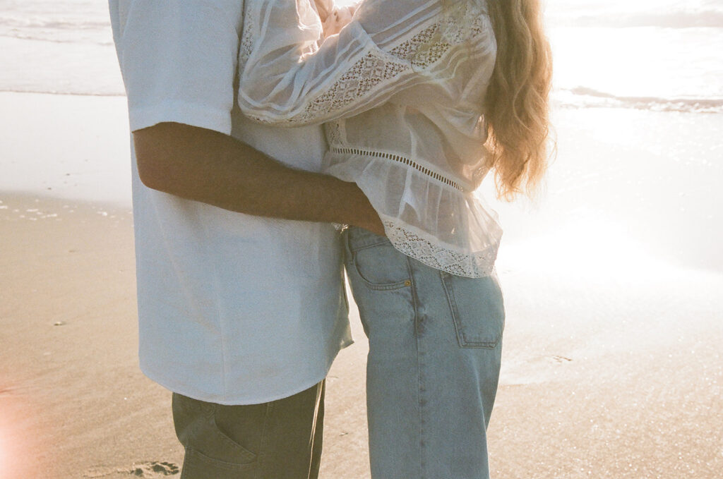 Couple takes beach engagement photos on the East Coast. Taken by a North Carolina engagement photographer