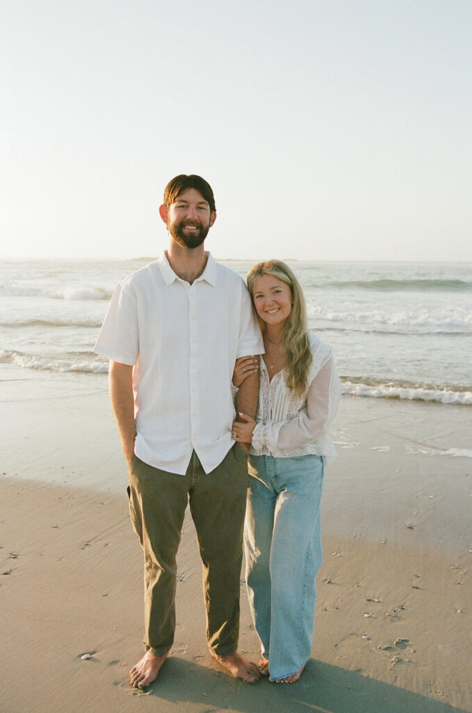Couple takes beach engagement photos on the East Coast. Taken by a North Carolina engagement photographer