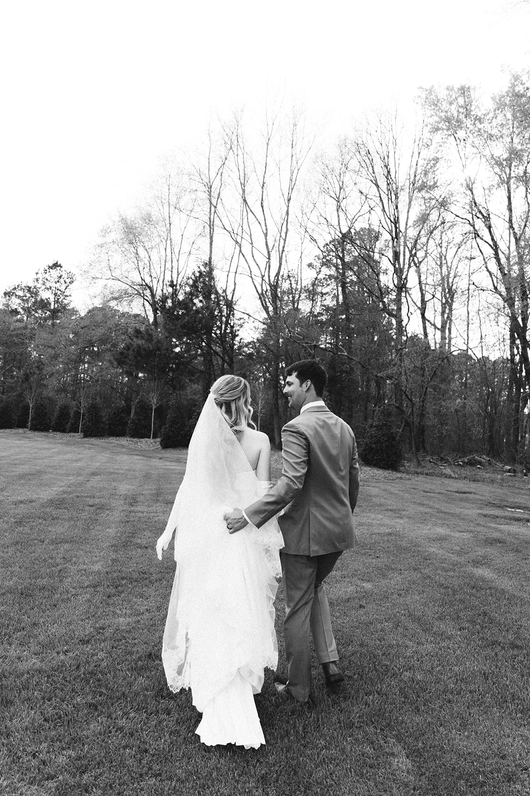  A bride and groom take wedding portraits outdoors taken by a North Carolina wedding photographer